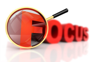 3D rendered illustration of magnifier aiming at the word Focus, focusing on one of its letters while the others are out of focus